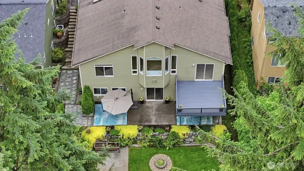 an aerial view of a house with a yard and garden