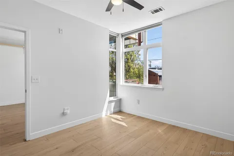 a view of a room with wooden floor and white walls