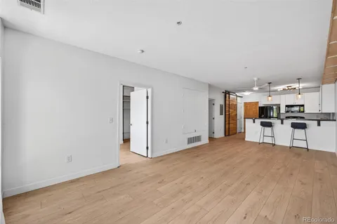 a view of a kitchen with stainless steel appliances granite countertop living room