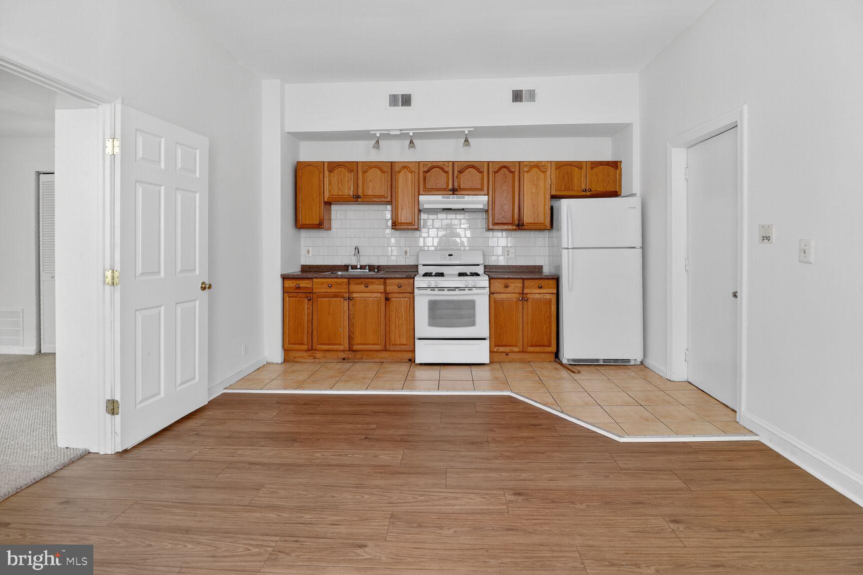 1404 Madison Avenue Baltimore, MD 21217 - Photo 17 of 54 a view of a kitchen with a stove wooden floor kitchen view and a window