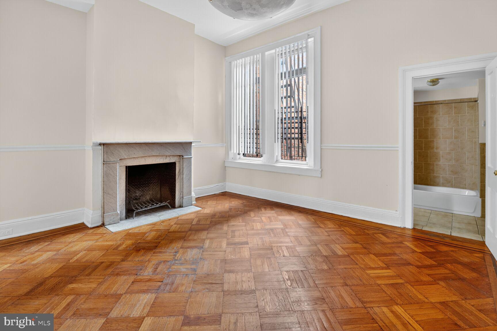 1404 Madison Avenue Baltimore, MD 21217 - Photo 25 of 54 an empty room with windows and fireplace