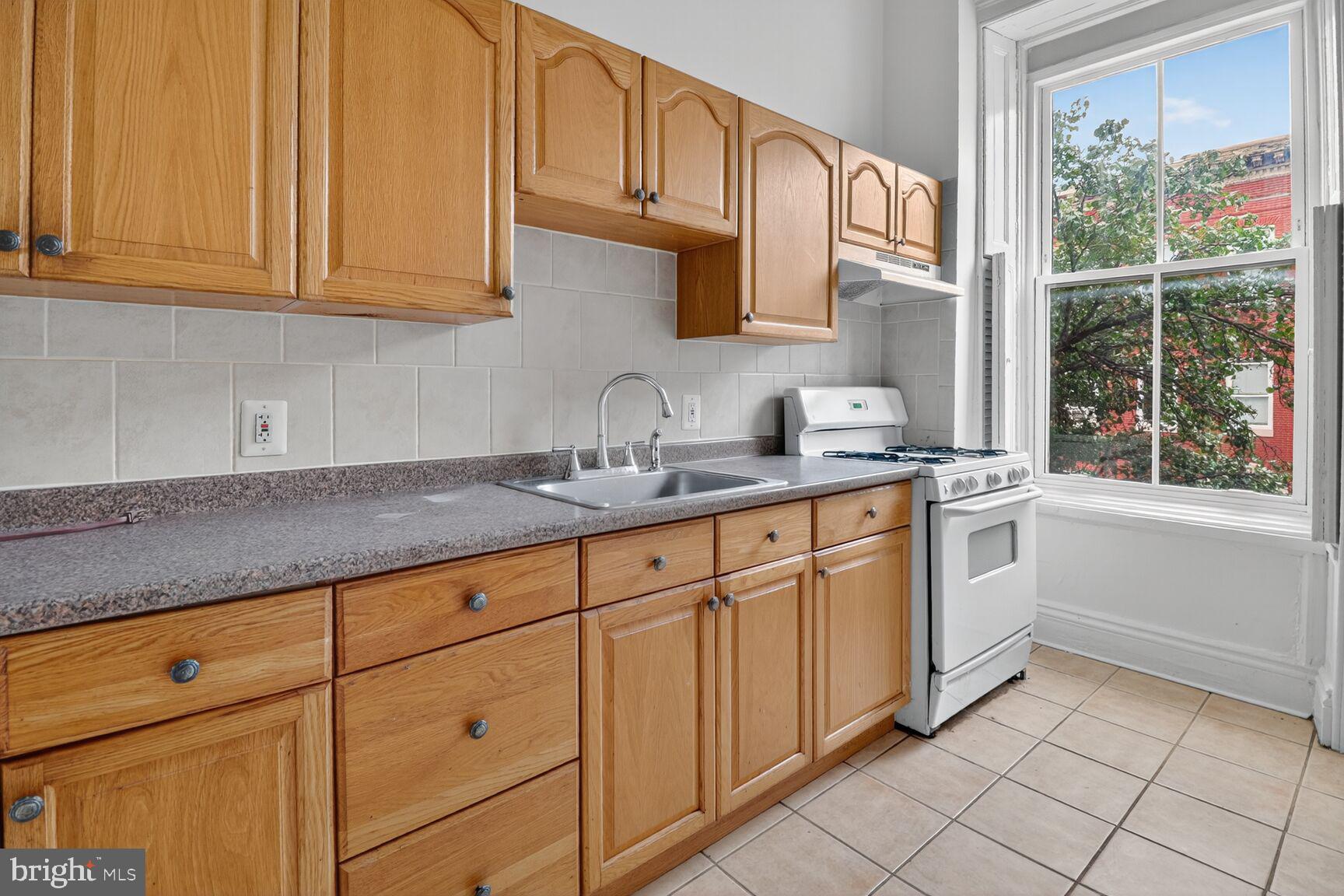 1404 Madison Avenue Baltimore, MD 21217 - Photo 28 of 54 a kitchen with stainless steel appliances granite countertop a sink and cabinets
