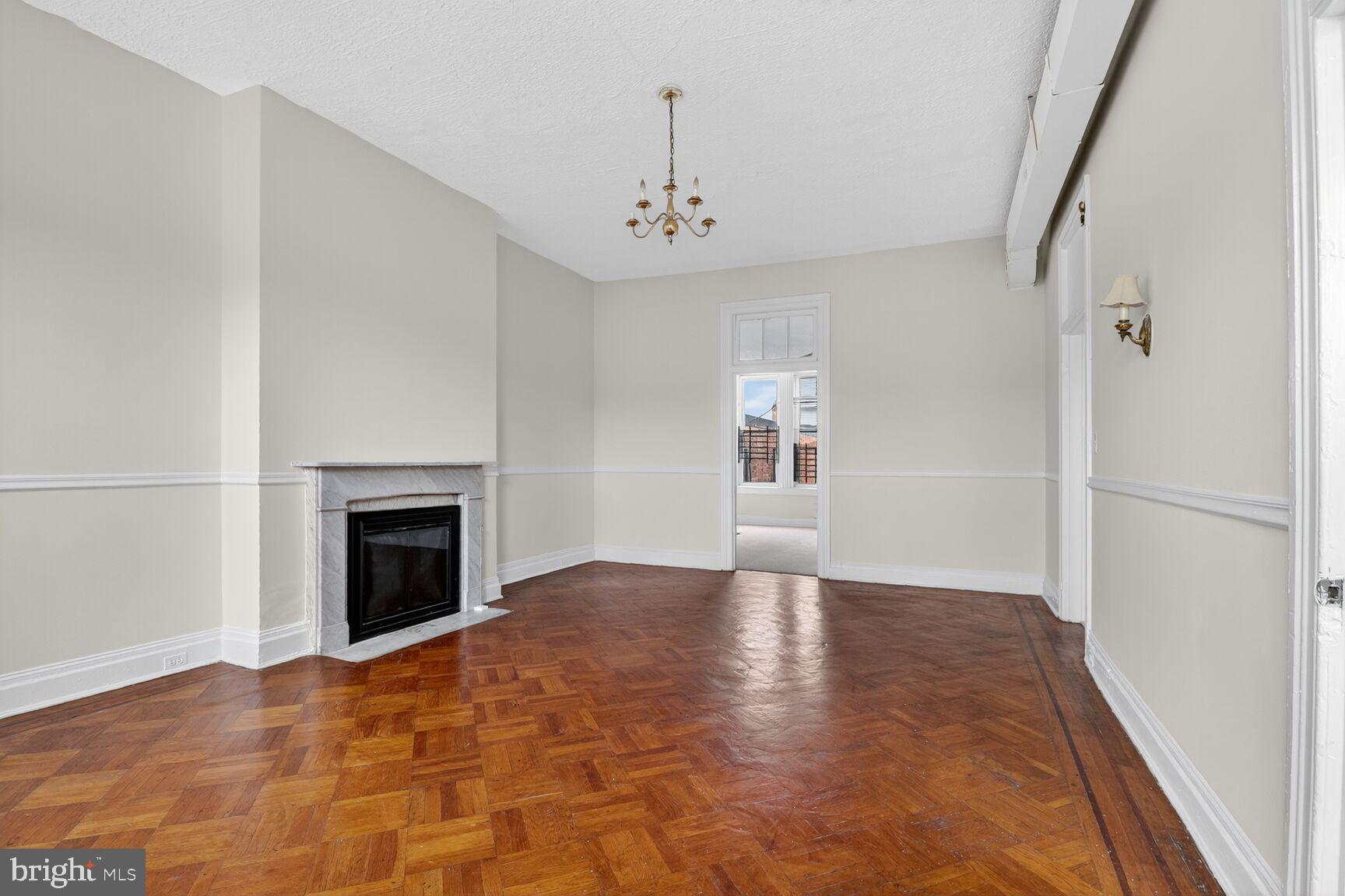 1404 Madison Avenue Baltimore, MD 21217 - Photo 35 of 54 an empty room with windows and fireplace