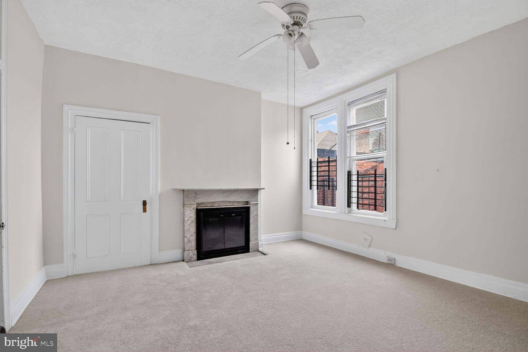 1404 Madison Avenue Baltimore, MD 21217 - Photo 42 of 54 an empty room with fireplace and windows