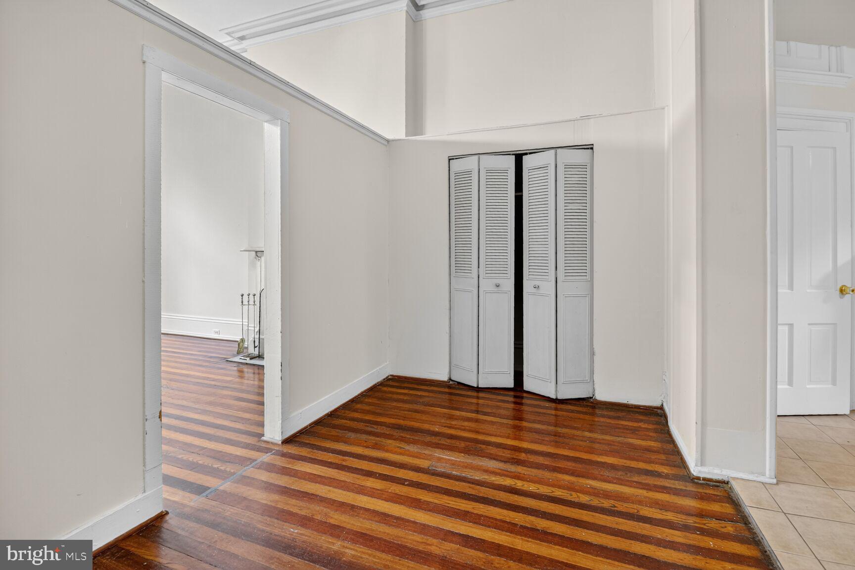 1404 Madison Avenue Baltimore, MD 21217 - Photo 7 of 54 a view of a room with wooden floor and white walls