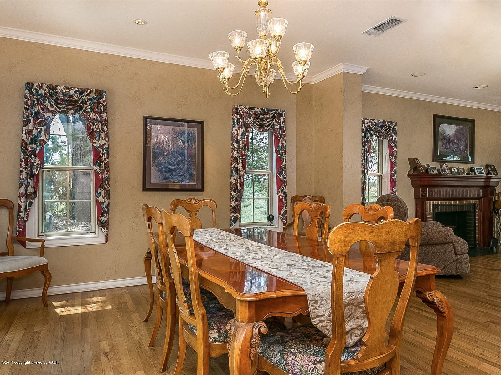 509 Fox Ridge Road Amarillo, TX 79118 - Photo 12 of 55 a view of a dining room with furniture and chandelier
