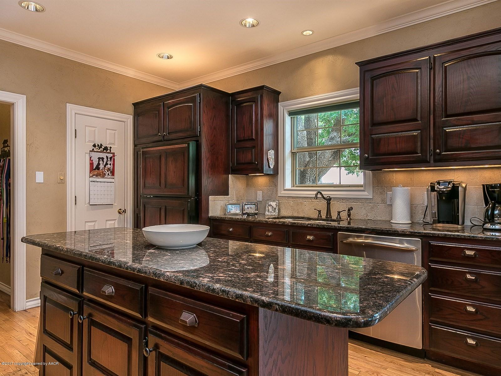 509 Fox Ridge Road Amarillo, TX 79118 - Photo 15 of 55 a kitchen with granite countertop cabinets stainless steel appliances a sink and a window