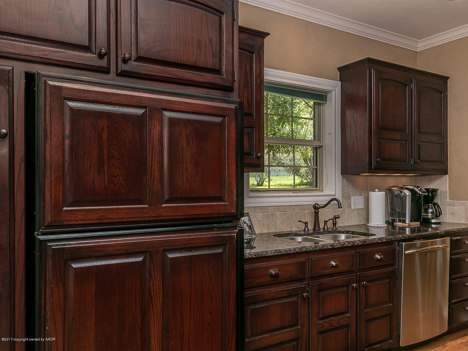 509 Fox Ridge Road Amarillo, TX 79118 - Photo 16 of 55 a kitchen with granite countertop cabinets stainless steel appliances and a window