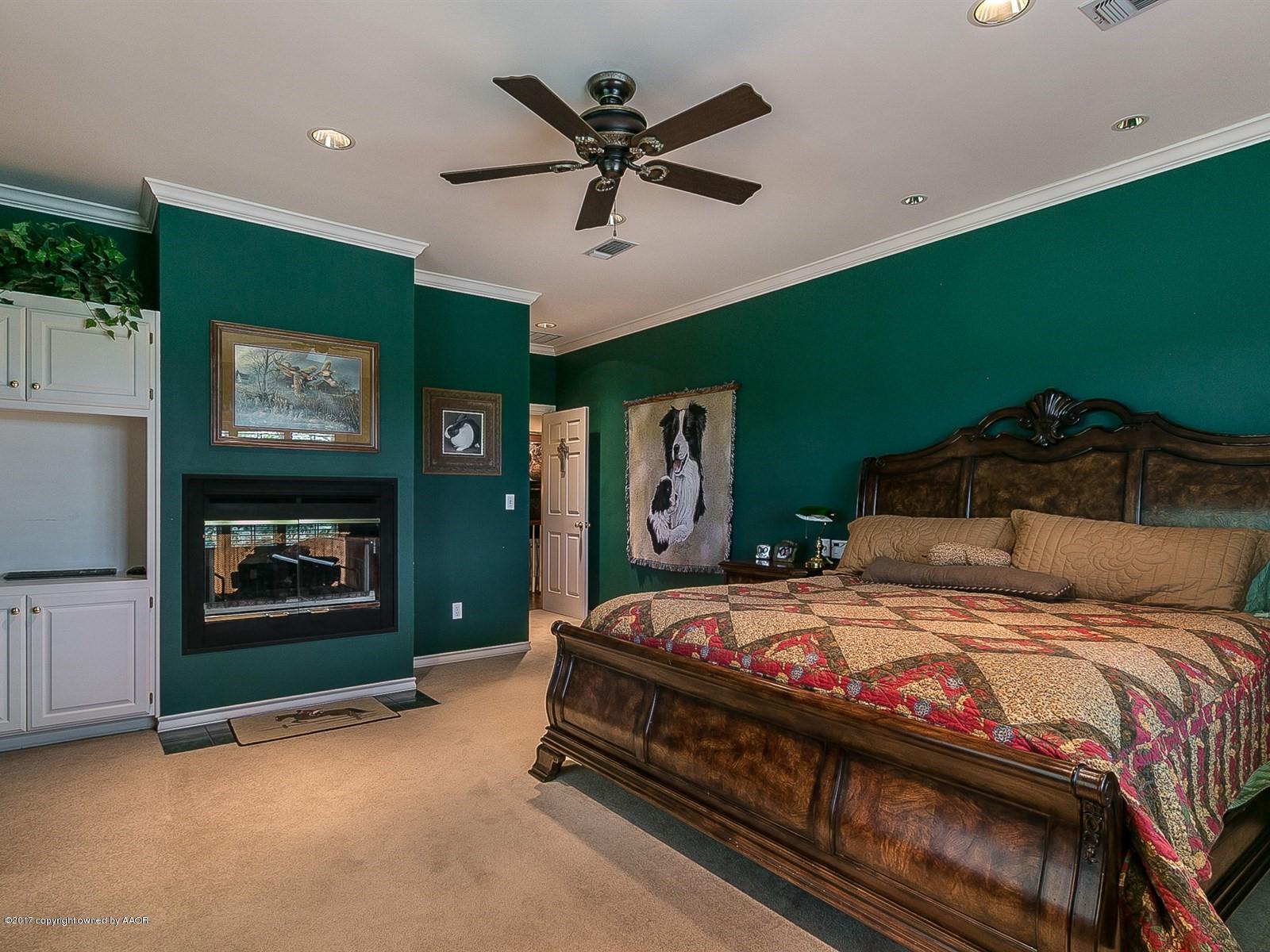 509 Fox Ridge Road Amarillo, TX 79118 - Photo 20 of 55 a bedroom with a bed and a fireplace