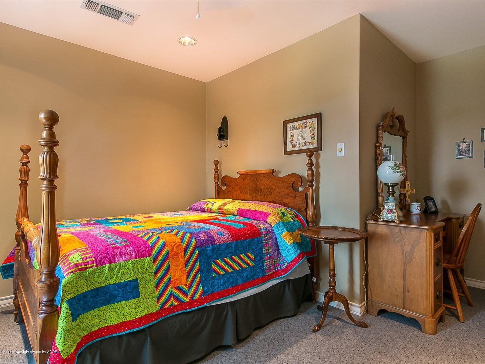 509 Fox Ridge Road Amarillo, TX 79118 - Photo 26 of 55 a bedroom with a bed and dresser