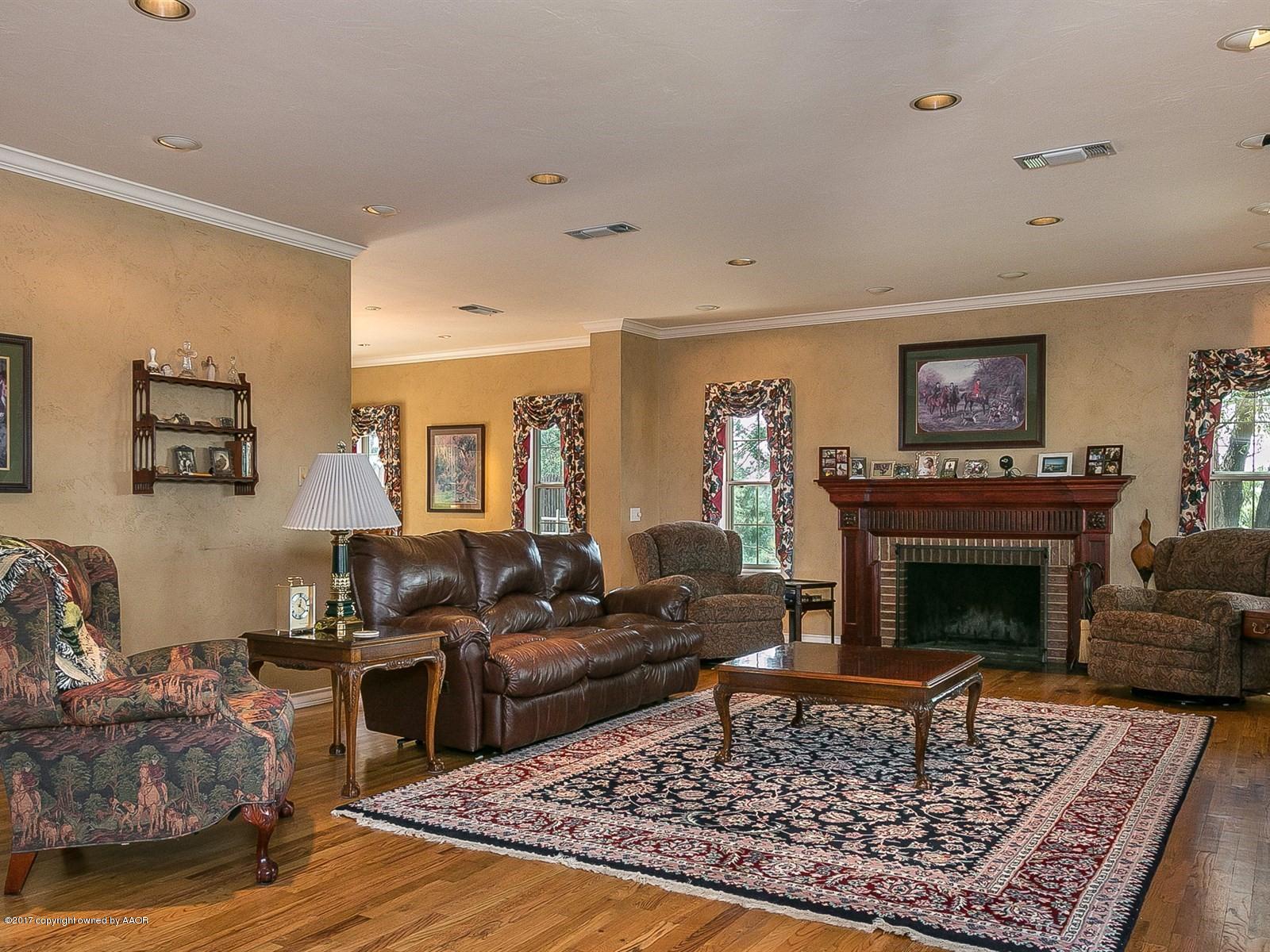 509 Fox Ridge Road Amarillo, TX 79118 - Photo 7 of 55 a living room with furniture and a fireplace