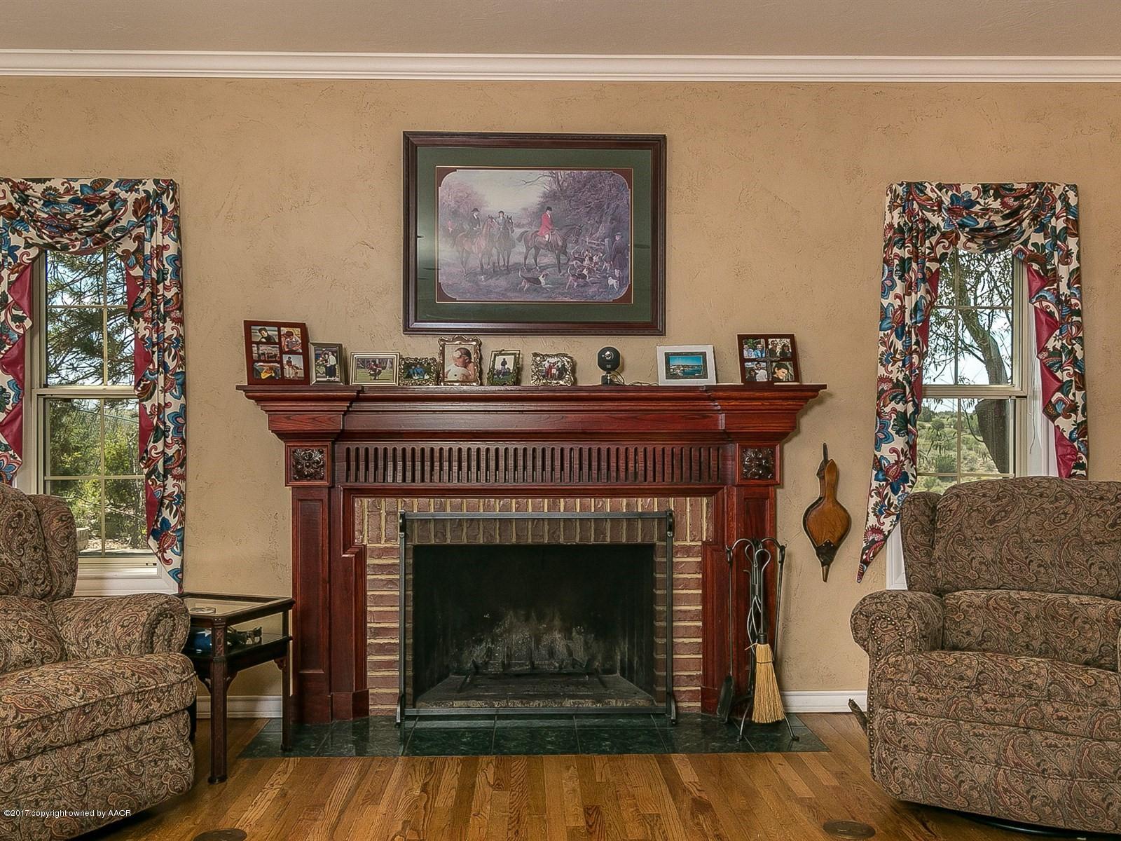 509 Fox Ridge Road Amarillo, TX 79118 - Photo 9 of 55 a living room with furniture a flat screen tv and a fireplace