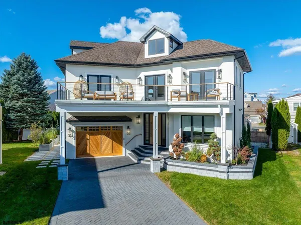 a view of a hallway with a livingroom and stairs
