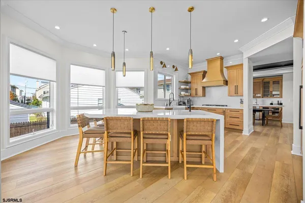 a kitchen with stainless steel appliances granite countertop a sink and a refrigerator