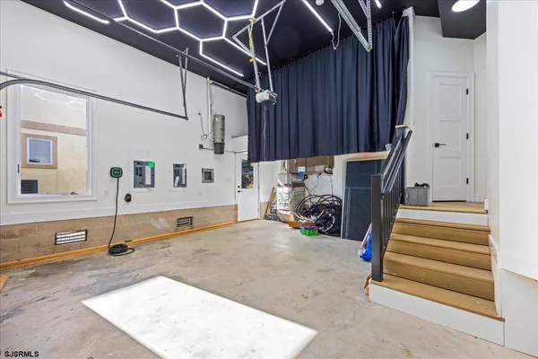a view of empty room with wooden floor and windows