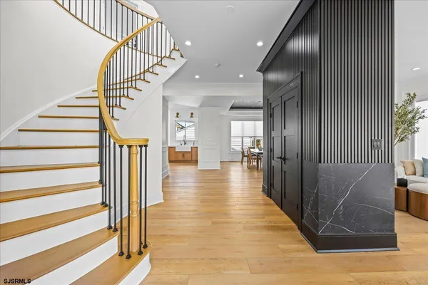 a view of an entryway with wooden floor