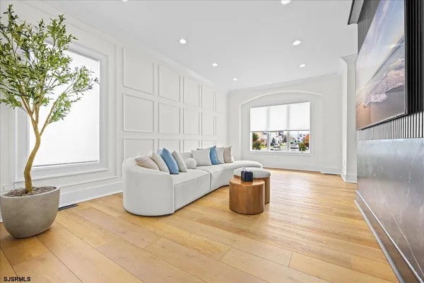 a dining room with furniture a rug and wooden floor