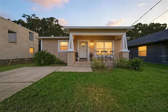 a view of a house with a small yard and a large window