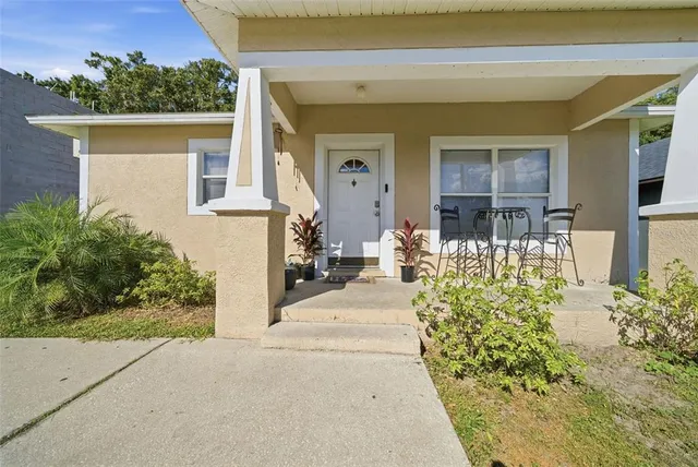 a view of a house with potted plants