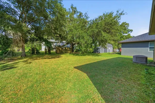 a view of a house with yard and sitting area