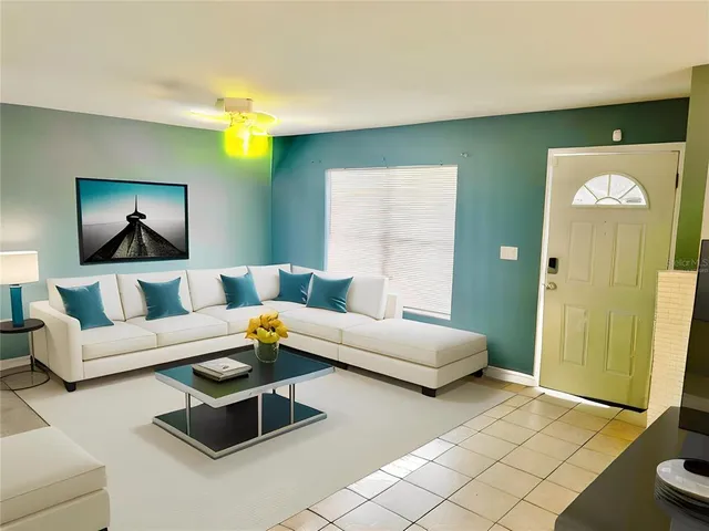 a living room with furniture and a chandelier