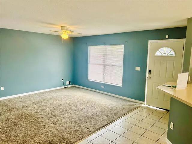 a view of empty room with window and wooden floor