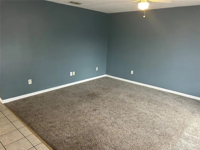 a large bedroom with a bed and lots of cabinets