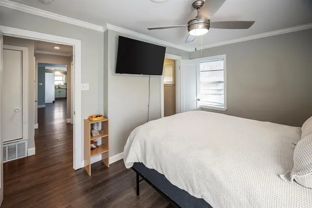 a bedroom with a bed and a flat screen tv