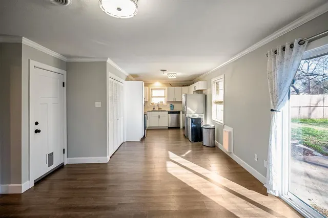 a view of a kitchen with a refrigerator and a window