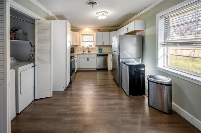 a kitchen with stainless steel appliances granite countertop a refrigerator a sink a stove and oven