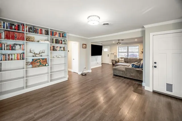 a view of a livingroom with furniture and an empty room