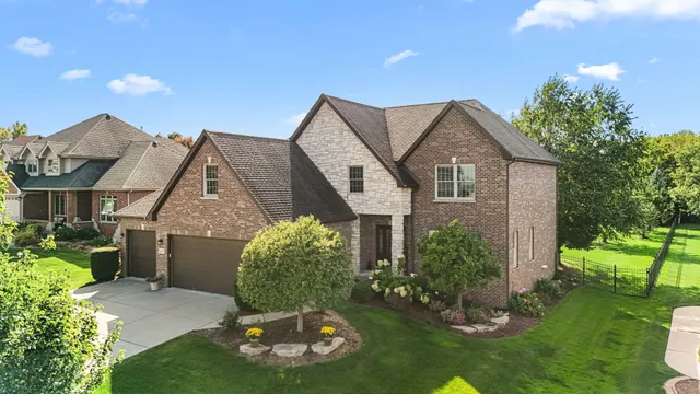 a aerial view of a house with a big yard and potted plants