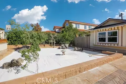 a view of house with yard and sitting area