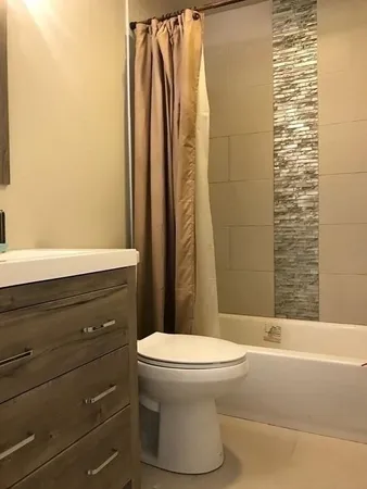 a bathroom with a toilet and shower