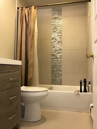 a bathroom with a shower and a toilet