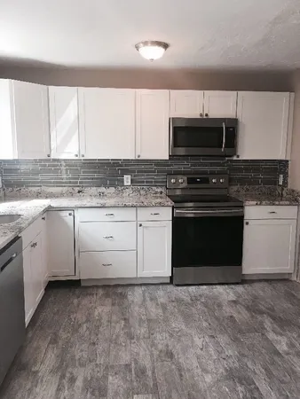 a kitchen with a stove sink and microwave