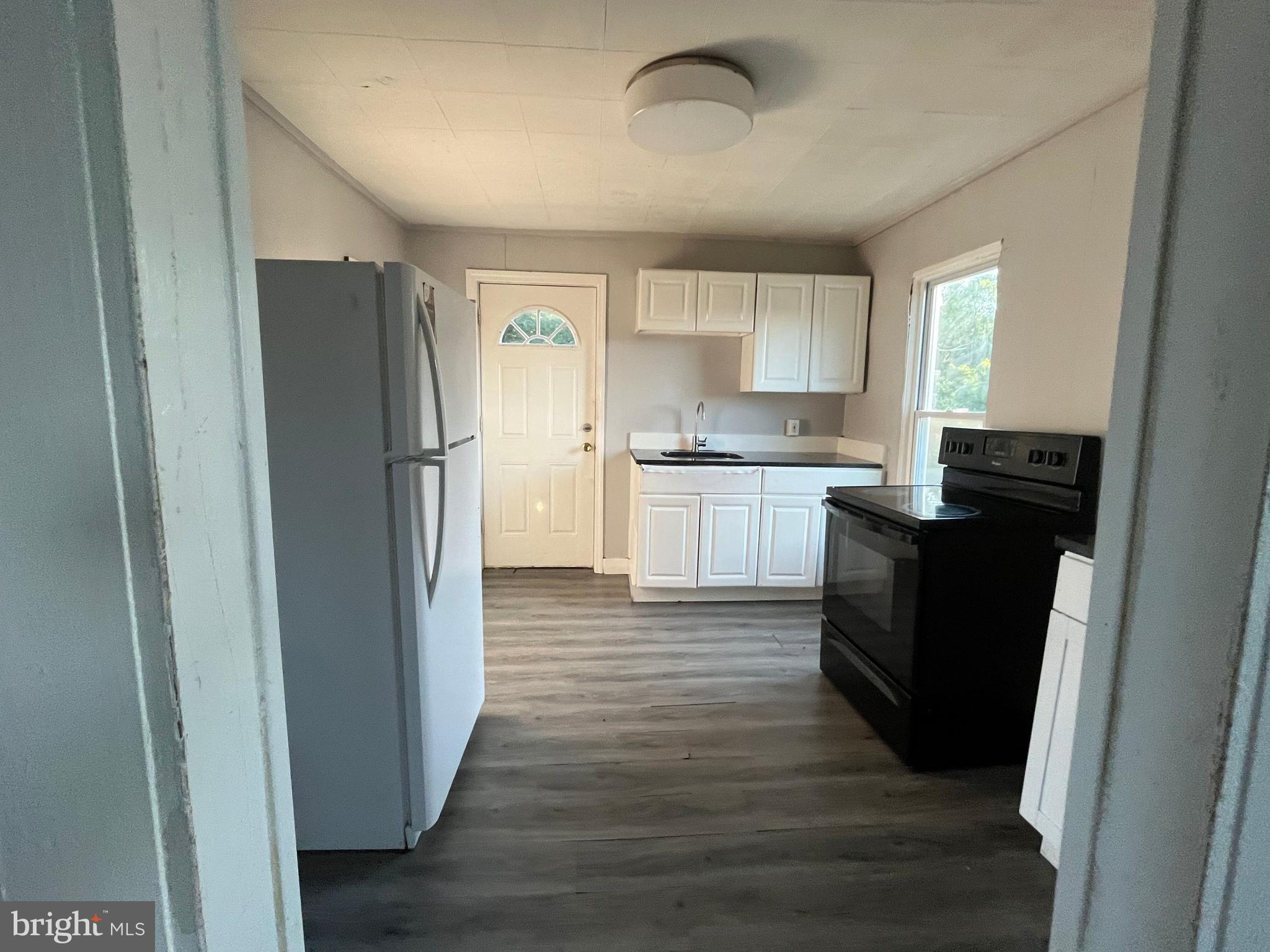 212 Rancocas Road Mount Holly, NJ 08060 - Photo 15 of 27 a kitchen with a refrigerator and a stove top oven
