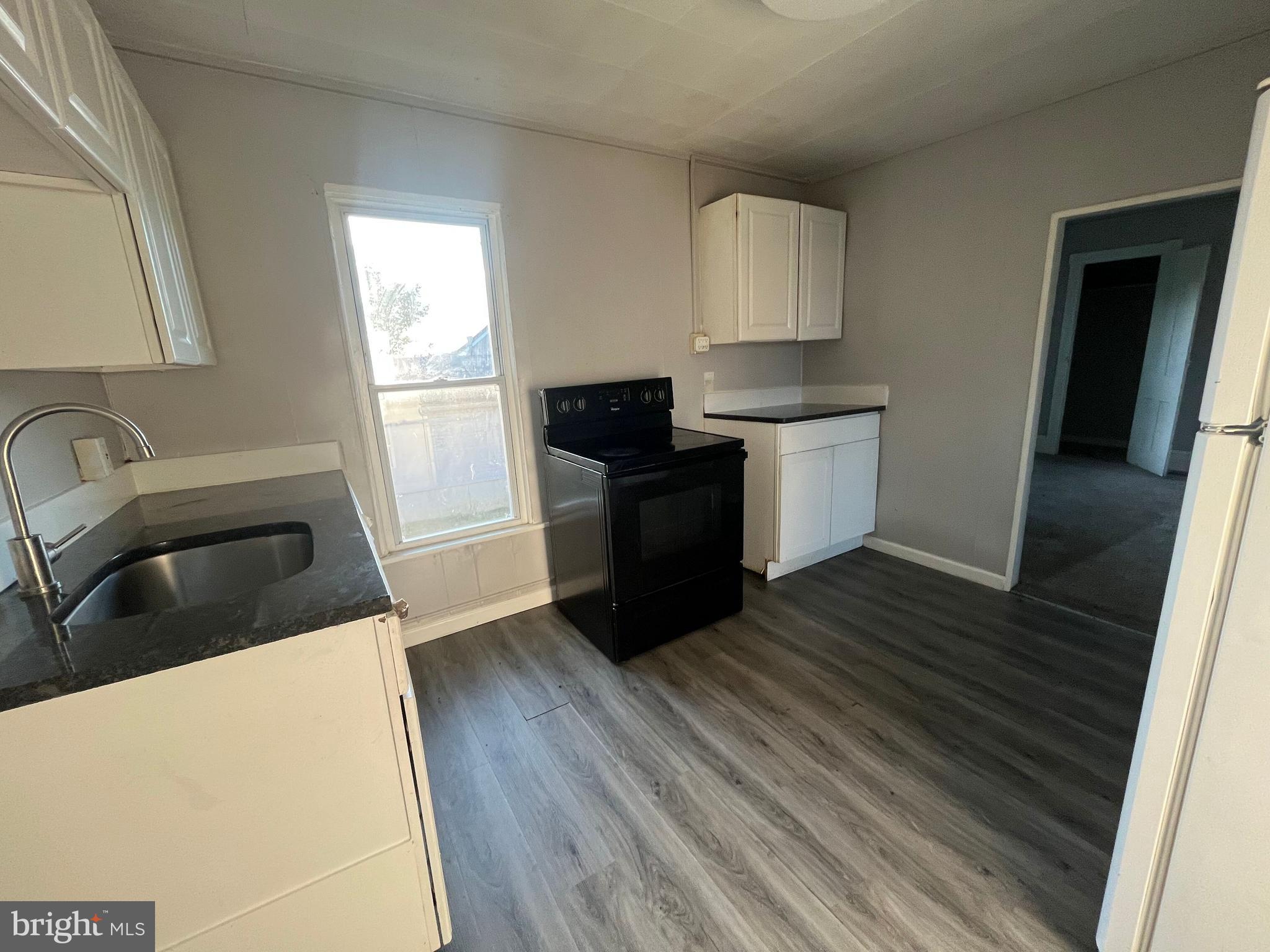 212 Rancocas Road Mount Holly, NJ 08060 - Photo 17 of 27 a kitchen with a refrigerator and a sink