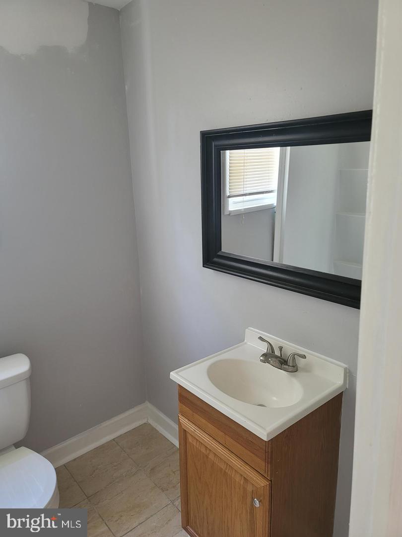 212 Rancocas Road Mount Holly, NJ 08060 - Photo 7 of 27 a bathroom with a sink toilet and mirror