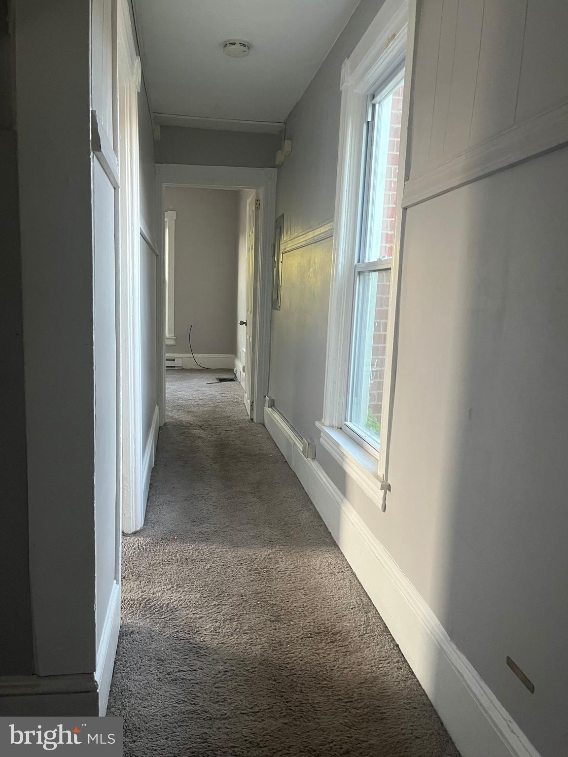 212 Rancocas Road Mount Holly, NJ 08060 - Photo 10 of 27 a view of a hallway with wooden floor and a living room