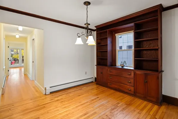 a view of a hallway with wooden floor and staircase