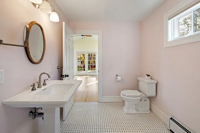a bathroom with a sink a mirror and a window