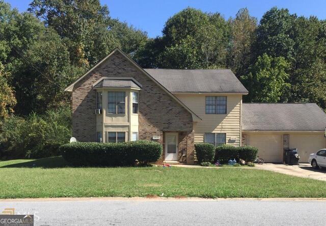 5826 North Castlegate Drive Atlanta, GA 30349 - Photo 1 of 1 a view of a house with a yard