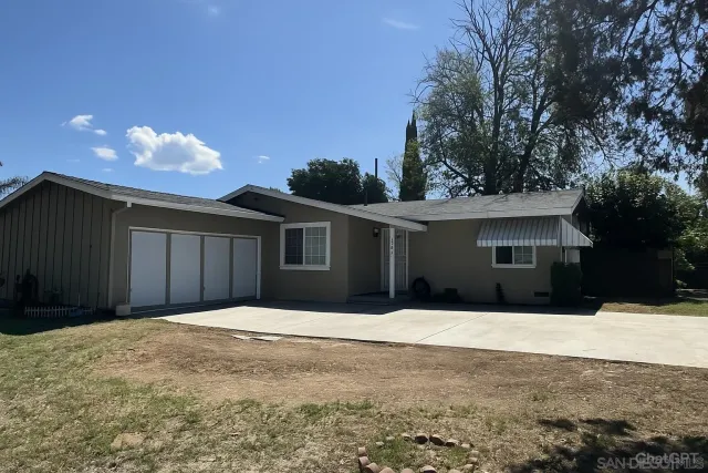 a house that has a tree in front of it