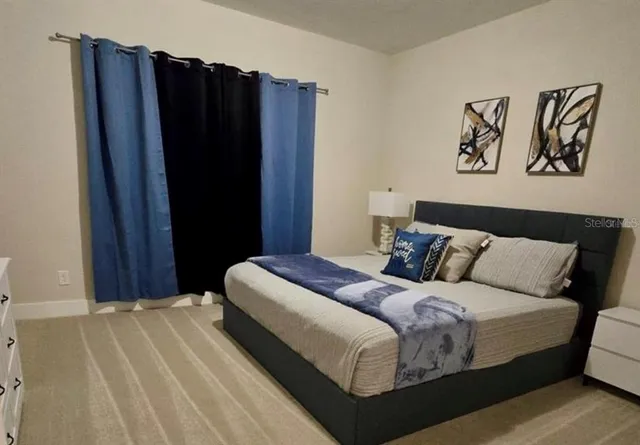 a bedroom with a bed and a walk in closet