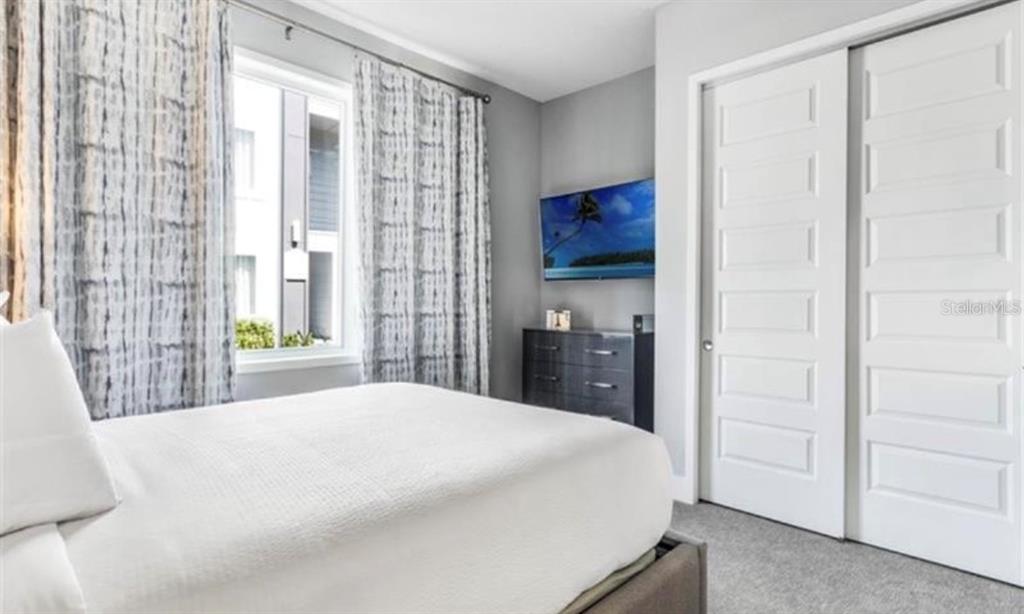7773 Spectrum Drive Reunion, FL 34747 - Photo 8 of 14 a bedroom with a bed and a large window