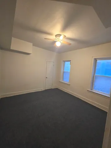 an empty room with a empty space and a window