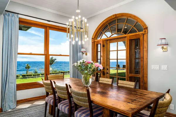 a kitchen with stainless steel appliances a table chairs and a chandelier