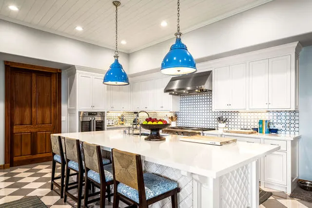 a kitchen with a stove a sink a dining table and chairs