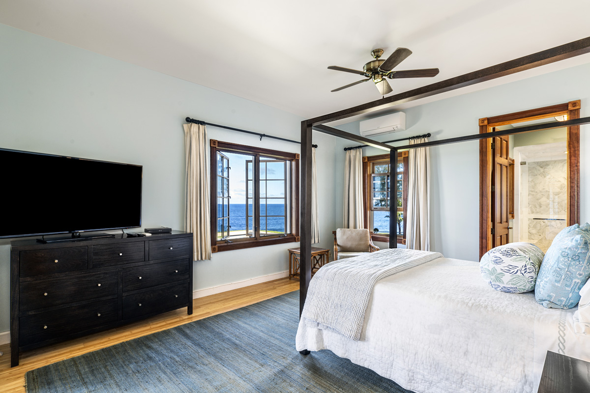 28-3628 Hawaiʻi Belt Road Honomu, HI 96728 - Photo 22 of 30 a bedroom with a bed and a flat tv screen on a dresser